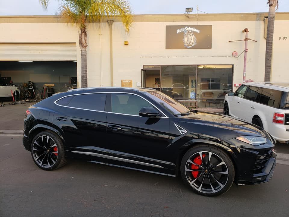 Black customer Lamborghini outside Auto Solutions