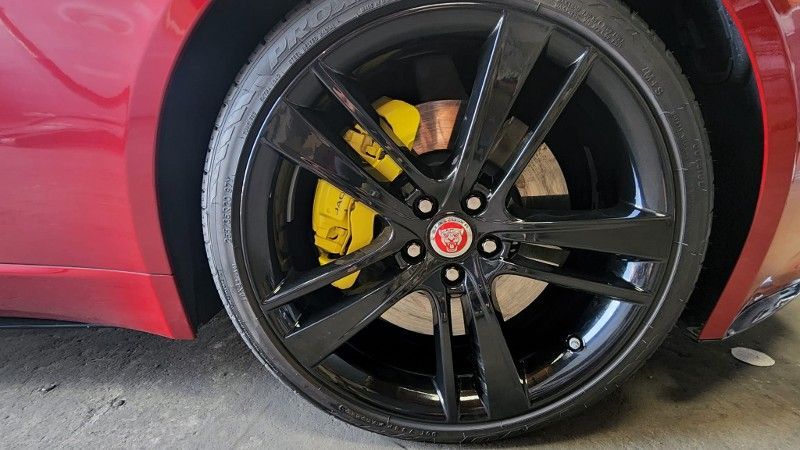 Black Jaguar wheel with custom yellow brake caliper
